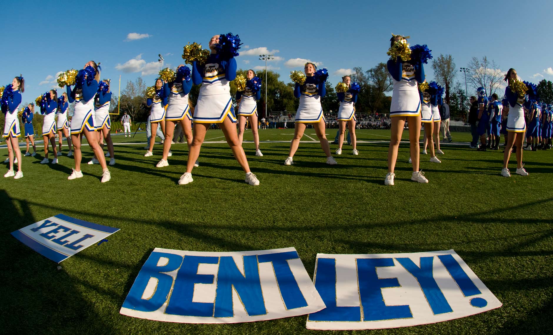 Wide angle photograph of cheerleaders at football game