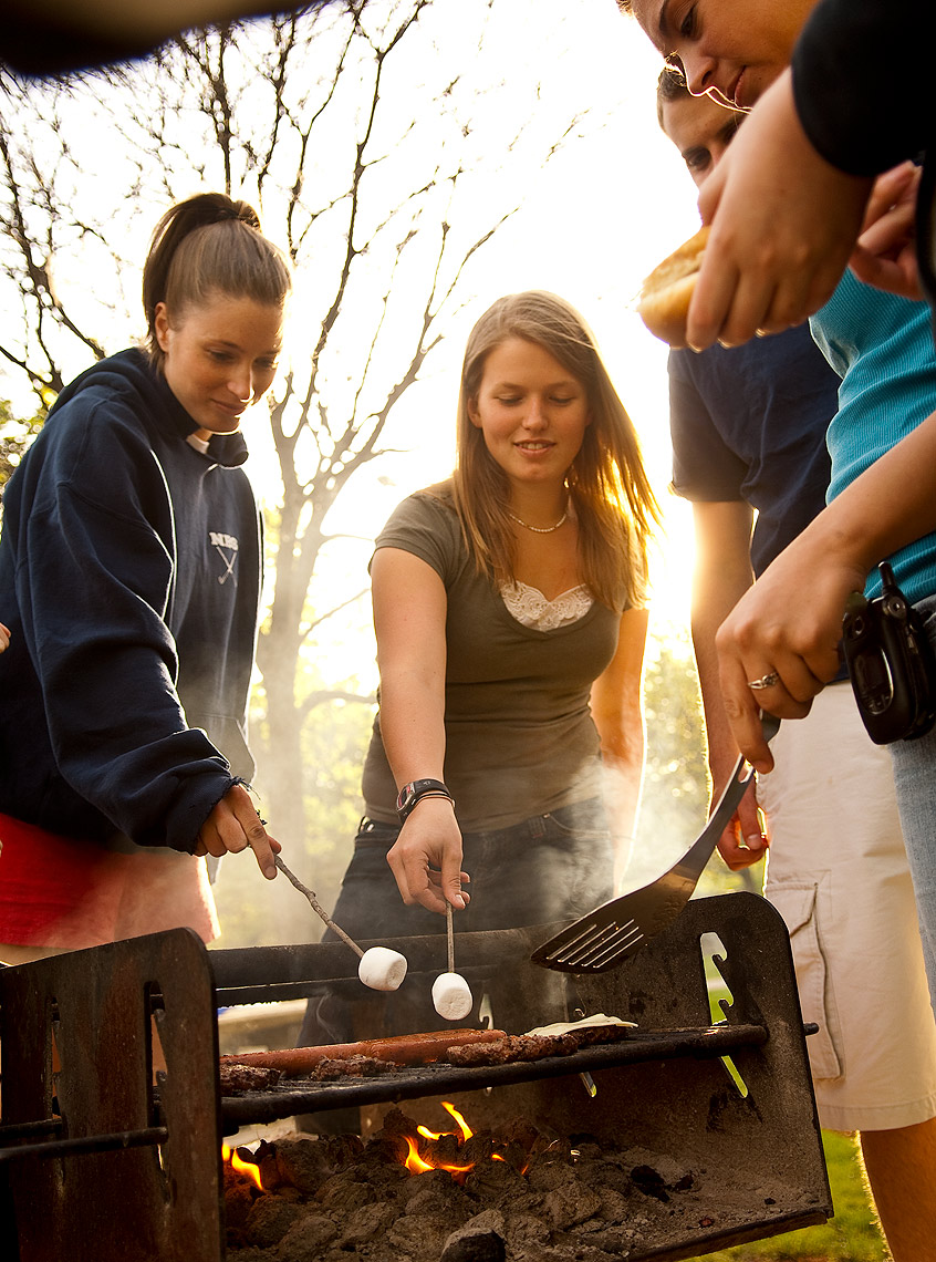 Coed students using outside grille at Bentley University in Waltham, MA.